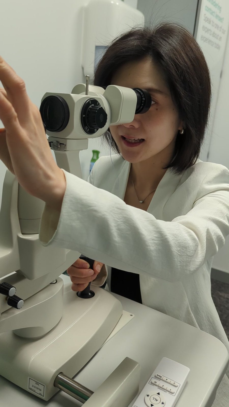 Dr. Laura Lin performing a clinical eye exam at Guildford Eye Clinic.