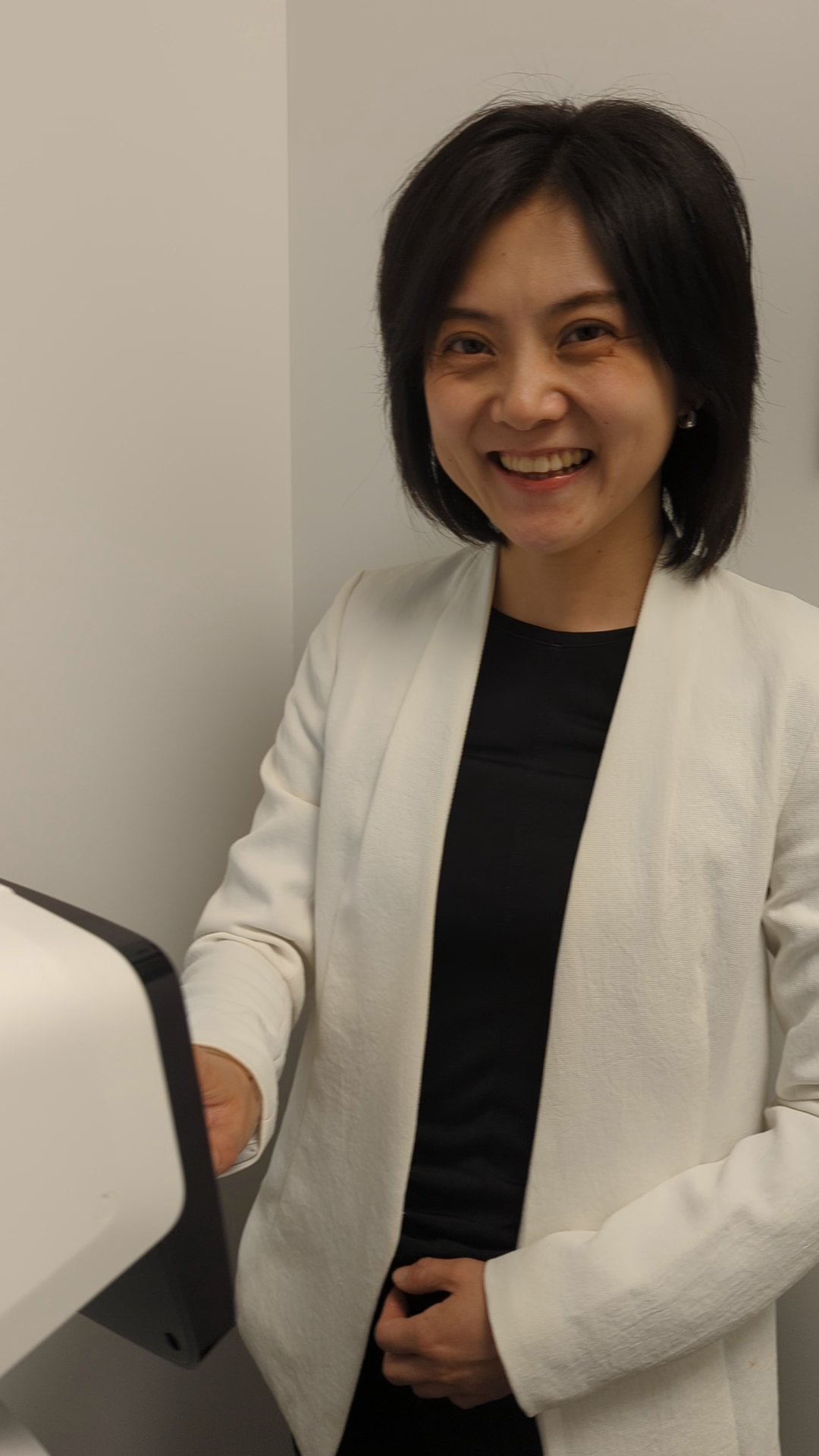 Dr. Laura Lin measuring a patient's eyes with the ocular biometer at Guildford Eye Clinic